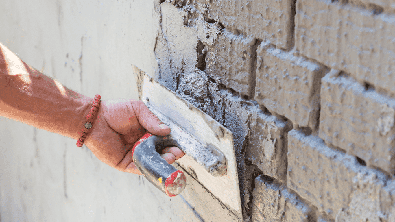 G Lee Plastering applying weatherproof external render to a property wall