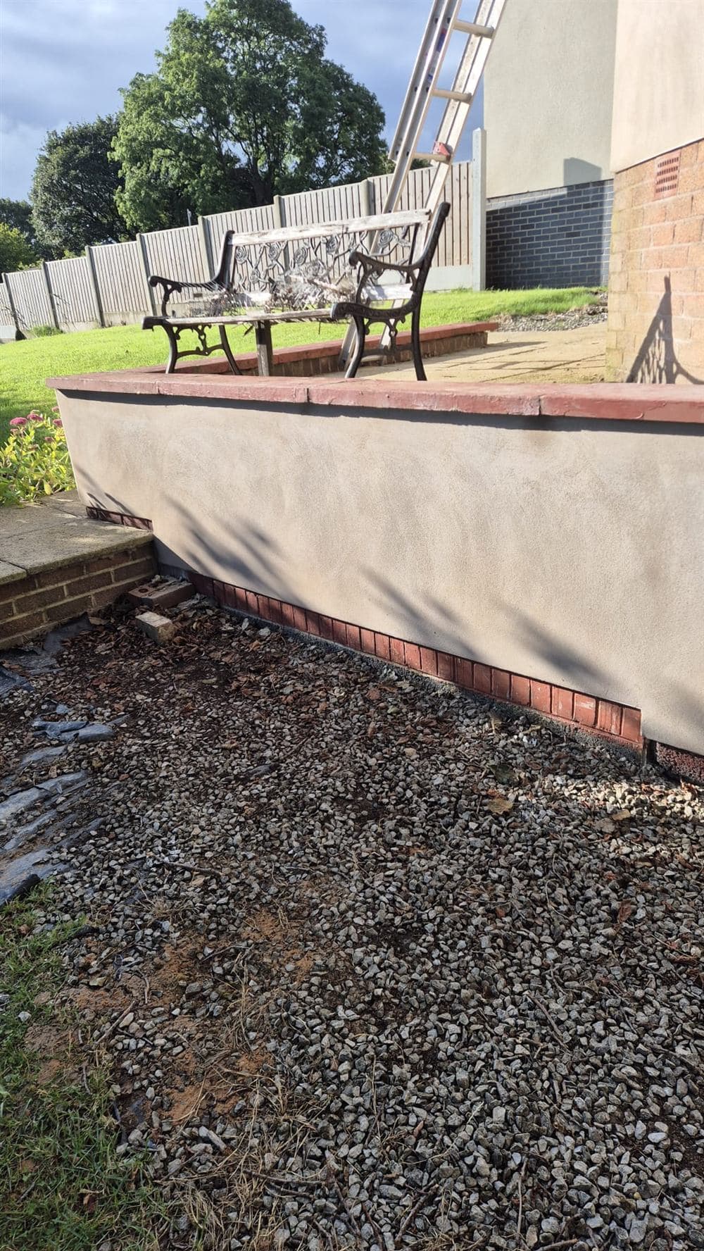 Completed sand and cement render on a garden boundary wall