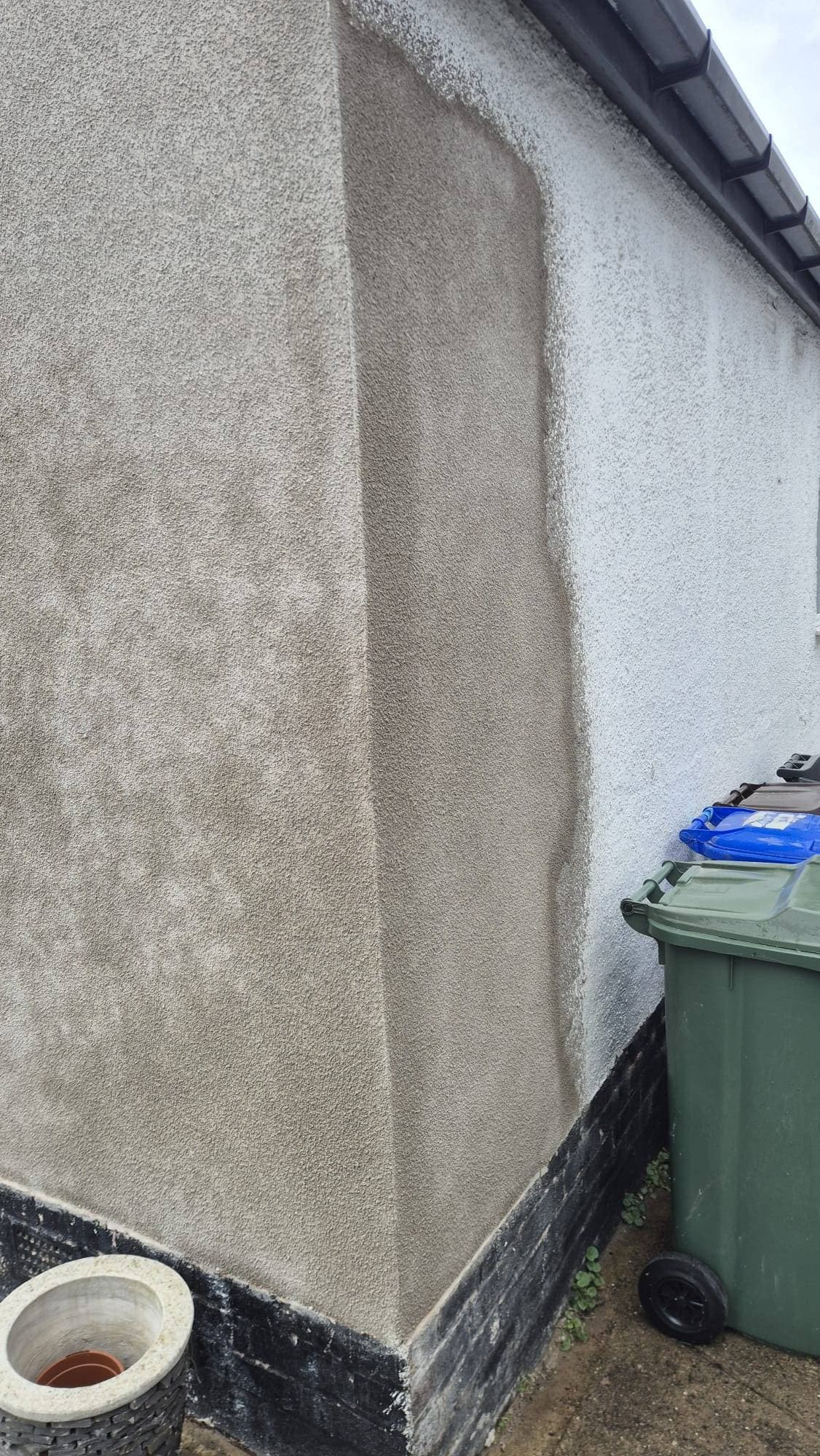 Corner render repair on a house exterior, tyrolean texture applied