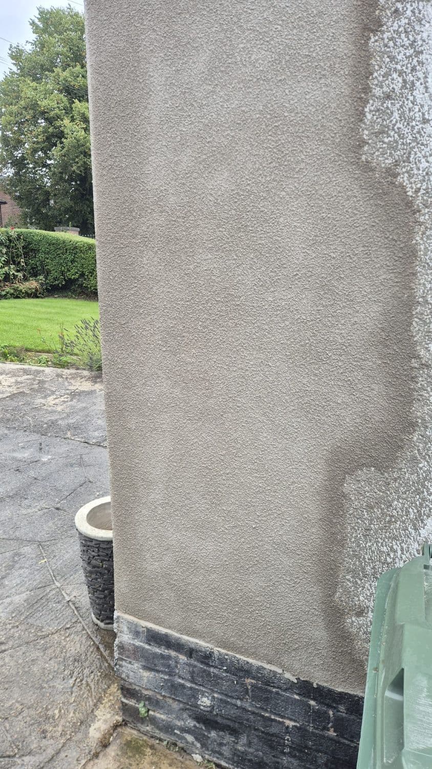 Completed render and tyrolean repair below a window on a house exterior